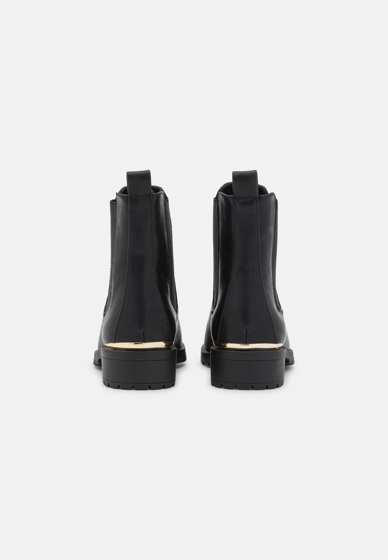Botas de tobillo de cuero negro con paneles laterales elásticos, que cuentan con un acento dorado en el tacón y una suela de goma texturizada.