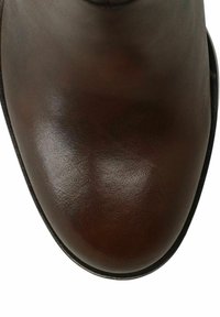 Dark brown leather boot with a smooth, glossy finish, rounded toe, and subtle stitching detail along the edges. Black sole accent.