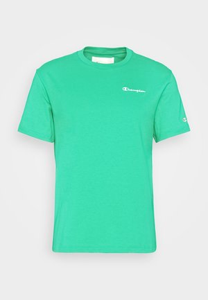 Zielona koszulka z krótkim rękawem i okrągłym dekoltem, z małym białym logo "Champion" na piersi i rękawie.