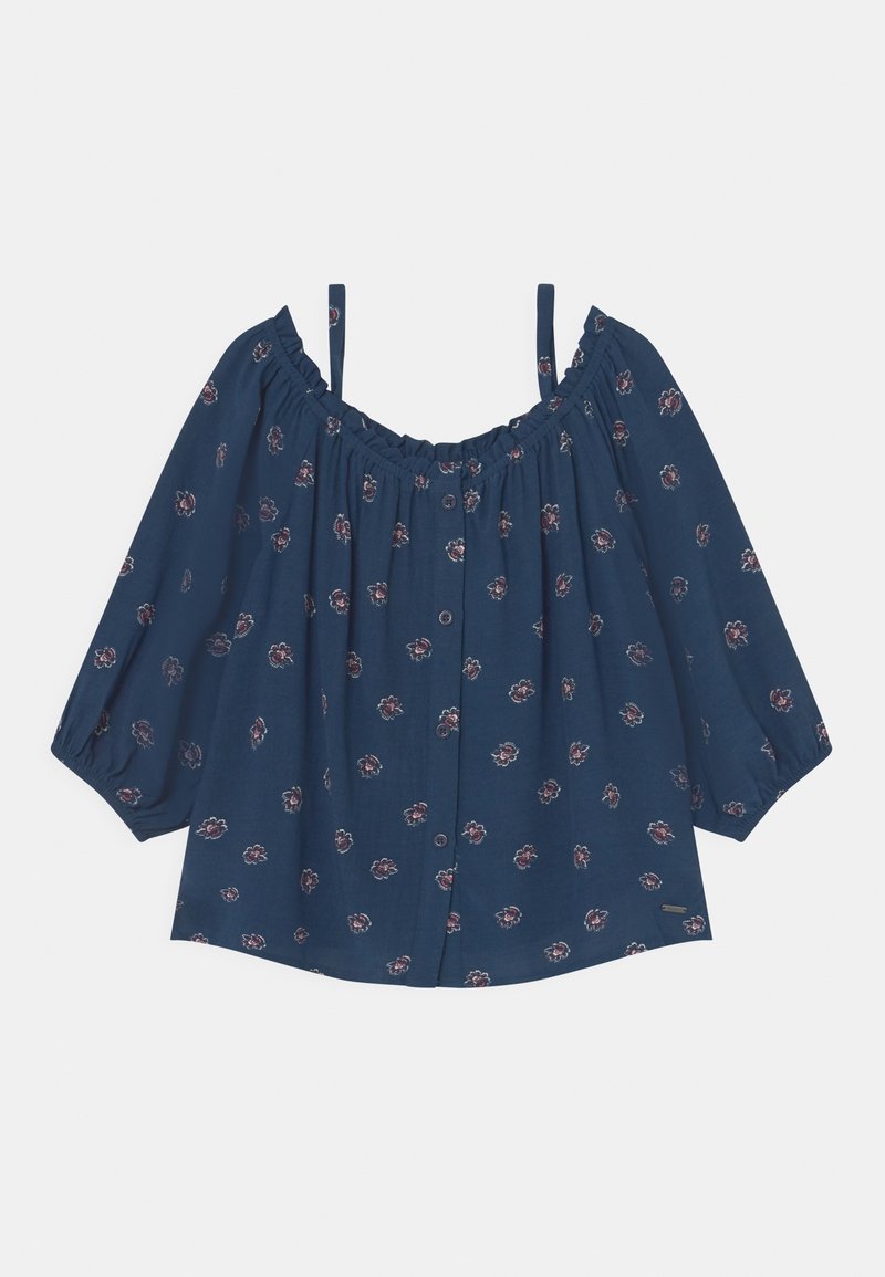 Blouse bleu marine épaules dénudées avec fines bretelles, boutonnée à l'avant, manches trois-quarts bouffantes et petit motif floral rose.