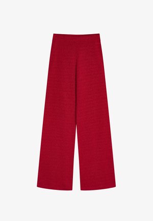 Punaiset leveälahkeiset housut, joissa on korkea vyötärö, valmistettu teksturoidusta kankaasta. Niissä on sileä vyötärönauha ja liehuvat lahkeensuut.