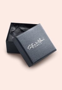 Schwarze, strukturierte Schmuckschatulle mit einem glatten Deckel, leicht geöffnet, der das schwarze Innenfutter und das weiß bedruckte Logo "Sofia Milani Jewels" zeigt.