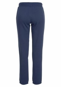 Marineblaue Jogginghosen mit elastischem Bund, schmal zulaufenden Beinen und gerippten Bündchen an den Knöcheln. Aus weichem, glattem Stoff gefertigt.