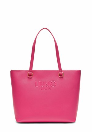 Sac fourre-tout synthétique rose avec deux bretelles, logo en relief, texture lisse et forme structurée. Garnitures en métal doré.