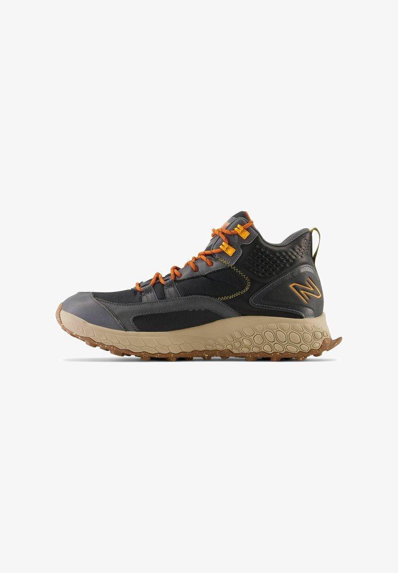 Mid-cut hiking shoe featuring a grey synthetic upper, orange laces, and a textured beige midsole with a rugged outsole for traction.
