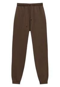 Hnědé bavlněné tepláky s nastavovací šňůrkou v pase, zúženými nohavicemi a elastickými manžetami. Hladký povrch, jednoduchý design, bez vzorů nebo akcentů.