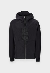 Black jacket made of lightweight fabric features a zip front, adjustable hood, and textured design with contrasting panel on the chest.