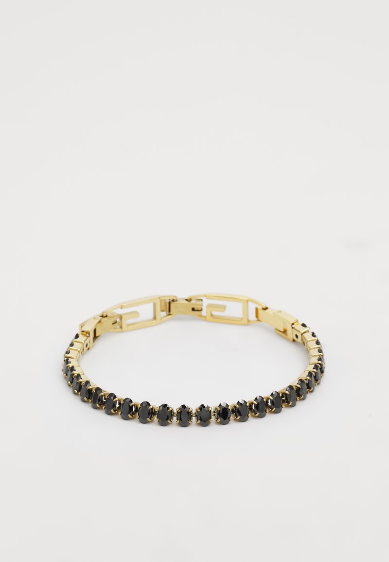 Kuldtooni käevõru, milles vahelduvad mustad kivid reas, geomeetrilise kujundusega kinnitusega ja poleeritud viimistlusega.