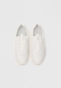 Pair of white lace-up sneakers with light gray detailing and rubber soles, viewed from above on a white background.