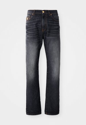 Dark blue jeans with a straight cut, featuring a faded effect, orange stitching, and a zipped fly with a button closure.