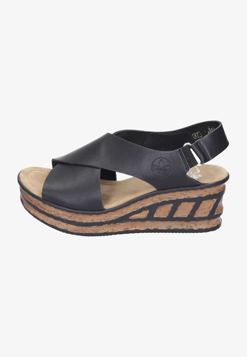 Black leather wedge sandal with crossover straps, cushioned footbed, and cork-textured platform. The sole features a cut-out design.