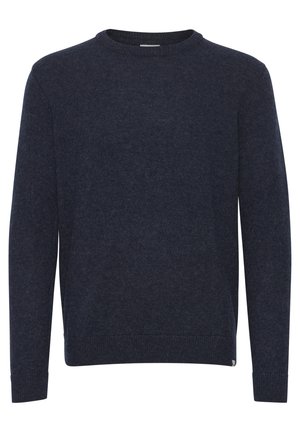 Tume sinine kampsun, mis on valmistatud pehmest ja tekstuuriga kangast. Omab ümarat kaelust, pikki varrukaid ning soonikkoes mansette ja allserva. Lihtne disain.