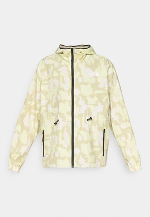 Jachetă impermeabilă de un galben deschis cu un model abstract alb, cu fermoar frontal, șnur ajustabil și accente negre. Prezintă două buzunare cu fermoar.
