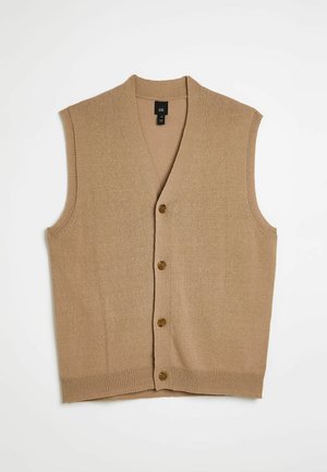 Beige mouwloze cardigan met een V-hals en vijf bruine knopen aan de voorkant. Gemaakt van zachte, gestructureerde gebreide stof.
