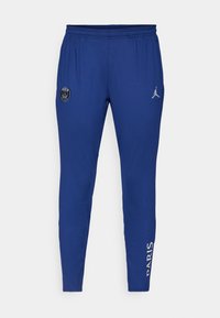 Pantalons de sport bleus avec une taille élastique, arborant un logo circulaire et le texte "PARIS" en blanc sur le côté. Fabriqués en tissu léger.