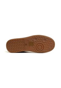 Suola di scarpa in gomma marrone con un motivo testurizzato, caratterizzata da accenti circolari e esagonali, e dettagli del marchio embossati al centro.
