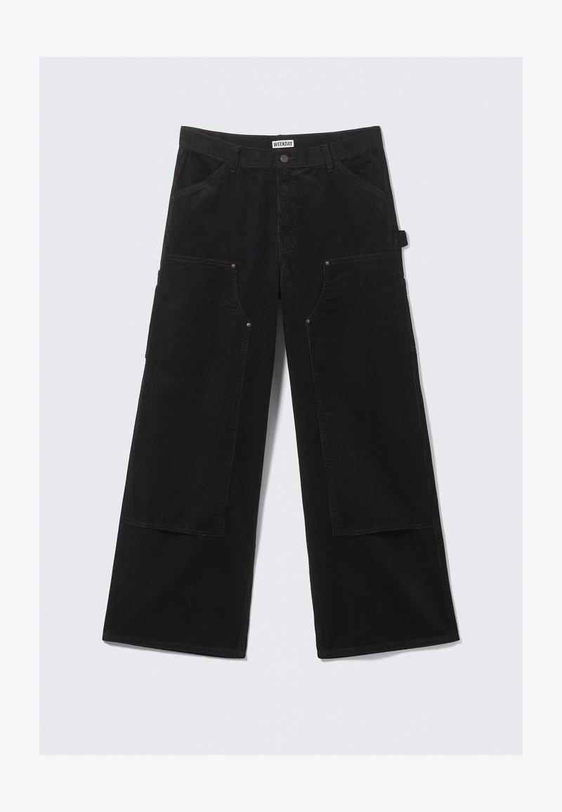 Pantalons en velours côtelé noirs à jambes larges avec grandes poches avant et passants de ceinture, dotés d'une fermeture à bouton et à zip.