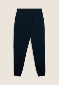 Pantalones jogger azul marino hechos de una tela suave, con una cinturilla elástica y puños, que cuentan con un solo bolsillo trasero.