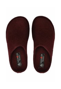 Et par burgunderfarvede uld slippers med rund tå, mærket "Haflinger," vist fra en top-down vinkel på en hvid baggrund.