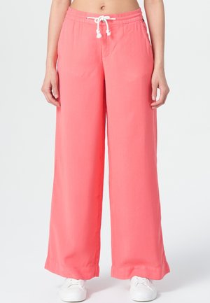 Pantalons larges corail avec taille élastique et cordon de serrage blanc. Fabriqués en tissu léger, dotés de poches latérales et d'une texture lisse.