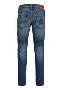 Dark blue denim jeans with faded areas, two back pockets with stitching, and a brown leather brand patch on the waistband.