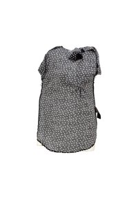 Grått tyg med ett mönster av små vita former, med en knuten krage och en rundad fåll. Mjuk och lätt utseende.