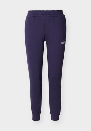 Pantaloni della tuta Puma blu navy con vita elastica, gambe affusolate e polsini alla caviglia, con un piccolo logo Puma sulla coscia sinistra.