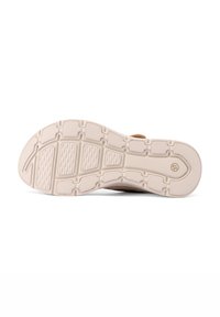 Suola della scarpa caratterizzata da una superficie in gomma beige chiaro e texturizzata, con un design del battistrada a motivo e un logo circolare, contrassegnata con la taglia 37.
