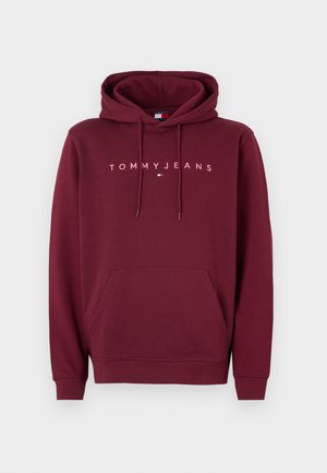 Burgundy hoodie with a kangaroo pocket, drawstring hood, and "TOMMYJEANS" logo in white across the chest. Soft fabric and ribbed cuffs.
