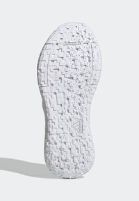 Suola delle scarpe in gomma bianca con superficie texturizzata, caratterizzata da schemi geometrici e il logo "Continental" verso la parte superiore.