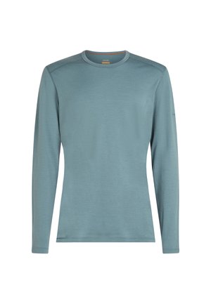 Long-sleeve shirt in soft light blue fabric with a round neck, flat seams, and a minimalist design, featuring no visible patterns or graphics.
