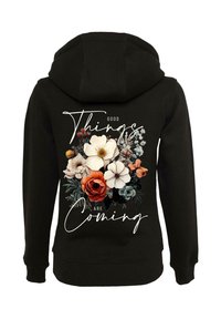 Black hoodie featuring a floral graphic on the back with the text "Good Things Are Coming" in white, accented by vibrant flowers.