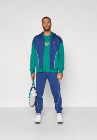 Mizuno ATHLETICS JACKET Felpa con zip estate blue/blu