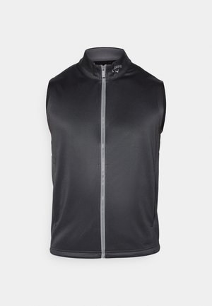 Gilet senza maniche di colore nero realizzato in un tessuto liscio e leggero. Presenta un colletto alto e una zip frontale con una striscia riflettente.