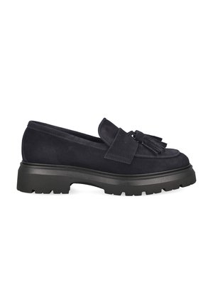 Black suede loafer with chunky sole and tassel detail on top, shown from the side on a white background.