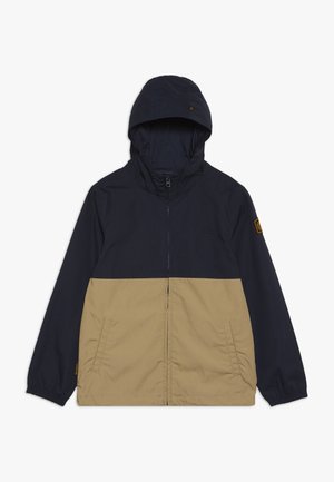 Kurtka z kapturem z granatową górną częścią i beżową dolną sekcją. Wykonana z gładkiego materiału, z elastycznymi mankietami i bocznymi kieszeniami. Zapięcie na zamek błyskawiczny z przodu.