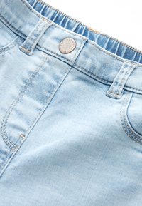 Ljusblå denimshorts med en slät yta, synliga sömmar, en knappstängning och en lätt tvättad effekt nära midjan.