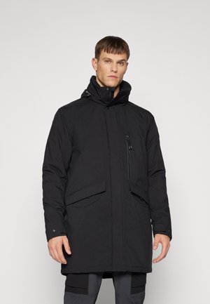 Black insulated parka jacket with a high collar, front zipper, side pockets, and a zippered chest pocket. Smooth texture, knee-length design.