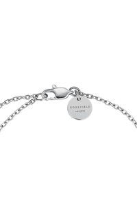 Silver chain bracelet featuring a lobster clasp and a round charm engraved with "ROSEFIELD" and "AMW NYC." Smooth texture and minimalist design.