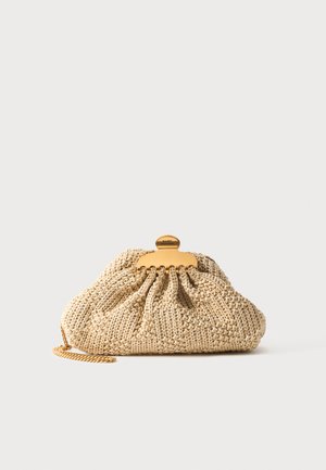 Beige crocheted clutch with gold chain and gold clasp engraved "Marc Jacobs" on a plain light background.