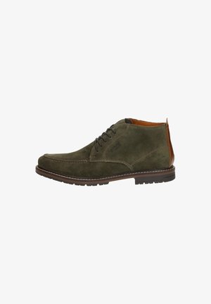 Dunkelgrüne Wildleder-Ankle Boots mit braunen Lederakzenten, runder Zehenpartie und gesteppten Details. Verfügt über eine Gummisohle mit Profil.