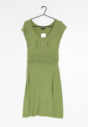 Grünes Kurzarmkleid mit Rundhalsausschnitt, gerafftem Detail an der Brust und einem ausgestellten Rock. Hat ein Pünktchenmuster.