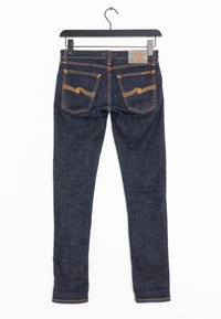 Mörkblå denimjeans med slim fit, med orange sömmar, två bakfickor och en lapp med texten "W" på midjebandet.