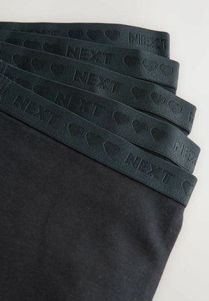 Schwarze Leggings mit einem dunkelgrünen elastischen Bund. Der Bund zeigt geprägt geschriebenen Text und Herzmuster. Weiche, glatte Textur.