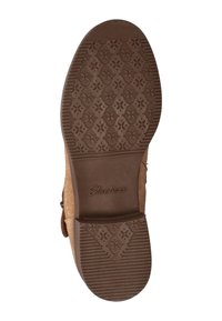 Bruine rubberen buitenzool met een bloemenpatroon, gestructureerde griplijnen en het "Skechers"-logo. De rand is versterkt voor duurzaamheid.