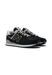 Black suede and mesh sneakers with a textured finish, featuring a prominent "N" logo, gray laces, and a white midsole. Classic running shoe design.