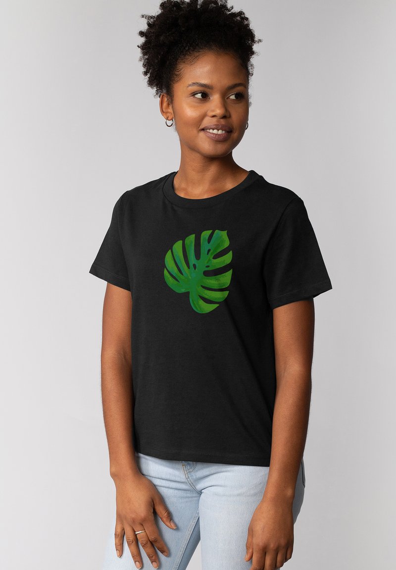 Schwarz T-Shirt mit einem grünen Monstera-Blatt-Design. Kurze Ärmel und klassischer Rundhalsausschnitt. Weicher Stoff.