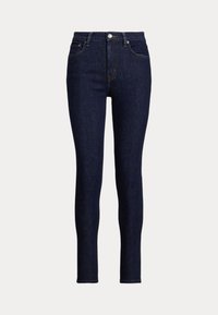 Donkerblauwe skinny jeans van denim. Bevat een hoge tailleband, voorzakken en een kleine metalen knop bij de gulp. Schone afwerking.
