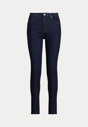 Jean skinny bleu foncé en denim. Présente une taille haute, des poches avant et un petit bouton en métal au niveau de la braguette. Fini propre.