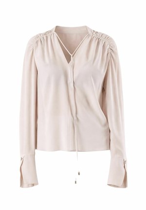 Blusa beige chiaro a maniche lunghe con spalle arricciate, scollo a V con dettaglio annodato e polsini allungati con chiusura a bottoni.